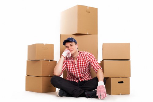 Packed boxes and furniture being loaded into a removals van
