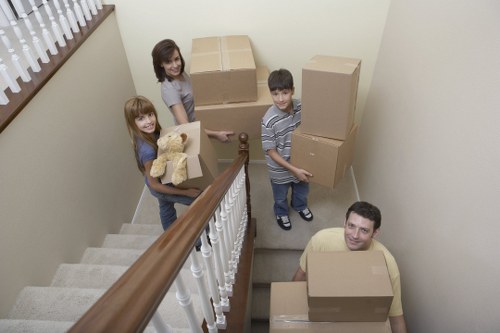 Removal crew unloading furniture and boxes at a new East Barnet property